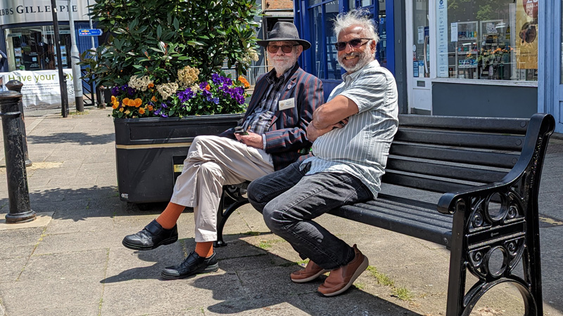 Former Chairman Michael Stimpson and new Chairman Ash Pattni sitting on a bench
